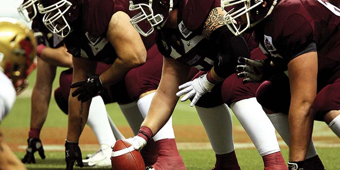 Football players getting ready for the play. Enjoy our football specials at Cheers Grille & Bar in Concord NH.