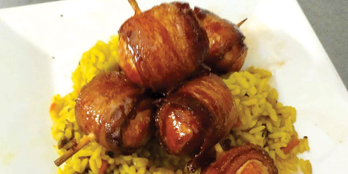 Enjoy succulent bacon wrapped scallops, served over rice at Cheers Grille & Bar in Concord NH.