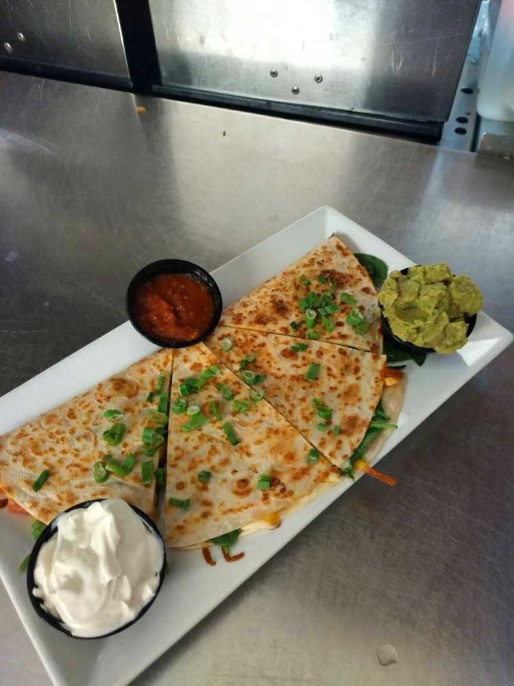 Warm and crispy quesadilla served with salsa, guacamole and sour cream at Cheers Grille & Bar in Concord NH.