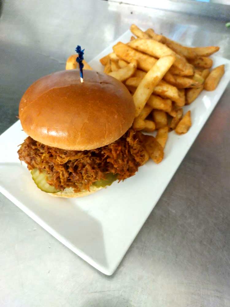 Delicious pulled pork sandwich served with fries at Cheers Grille & Bar in Concord NH.
